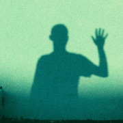 Shadow of a person waving.